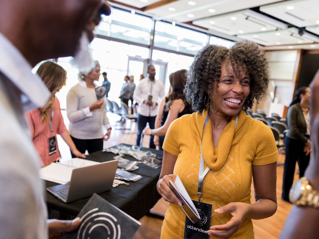 A First-Time Exhibitor'S Guide To Trade Shows 8 Exhibit attendee smiling