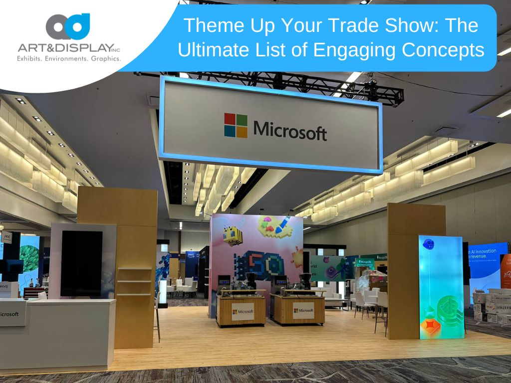 Large Microsoft trade show booth with hanging overhead sign, illuminated display panels, branded counters, and open layout showcasing interactive exhibits on a convention floor.
