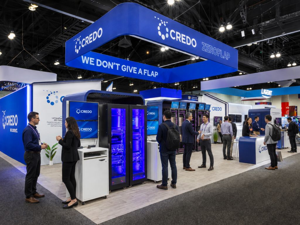 Exhibition booth design for credo at a trade show, featuring branded displays, engaging visuals, and interactive tech setups for showcasing their products. Attendees are networking and exploring the booth’s offerings in a modern, dynamic environment.