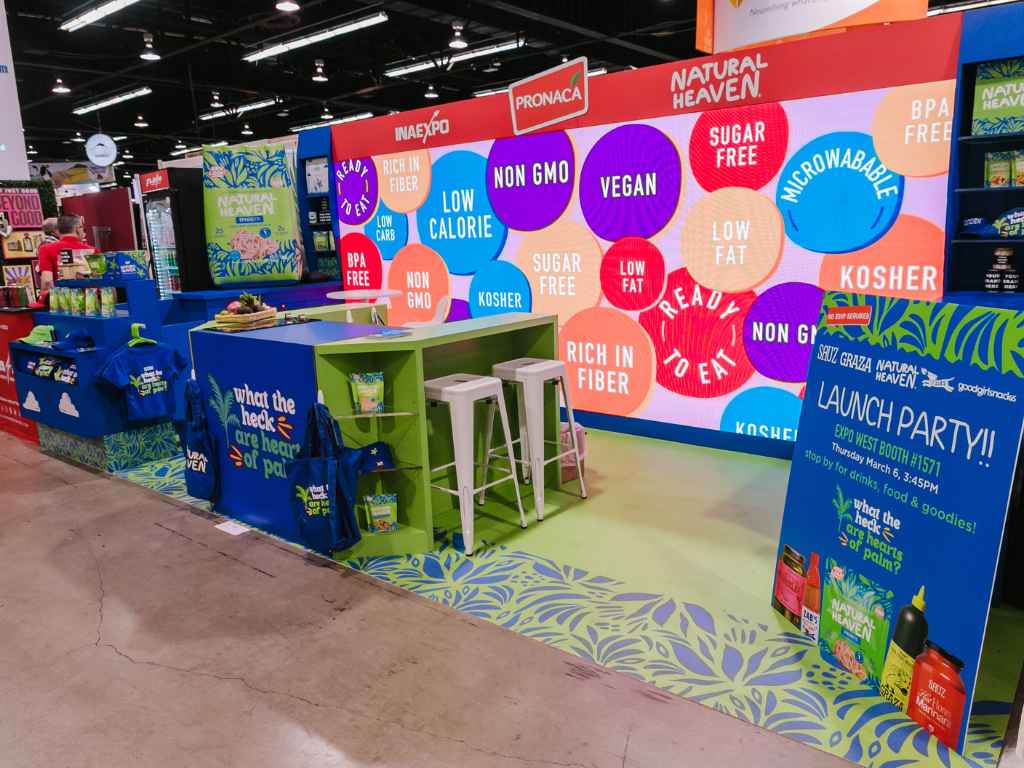 User-Inserted Custom branded trade show exhibit with colorful graphics and product display.